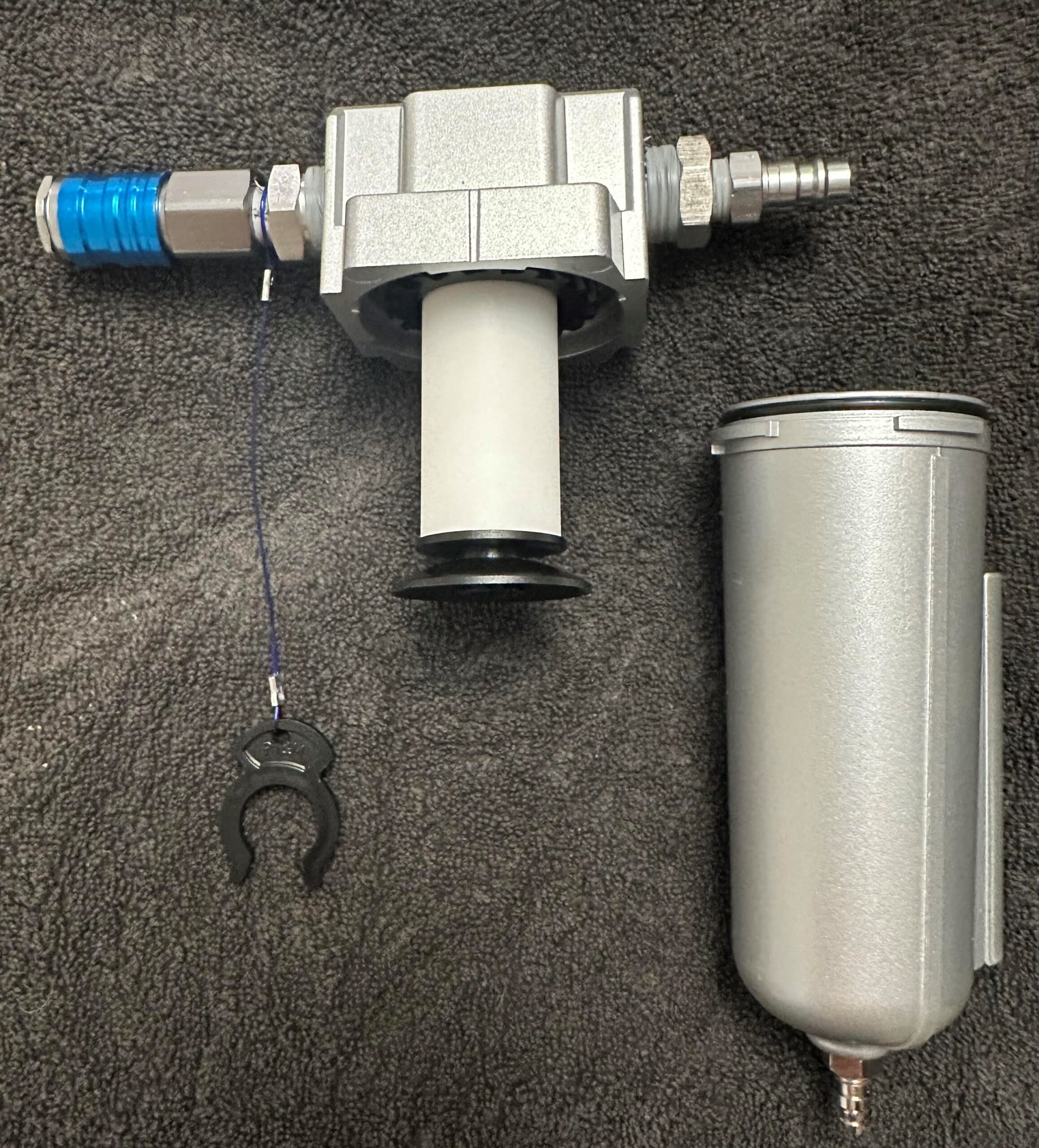 Air tool setup with filter, regulator, lubricator on a dark surface